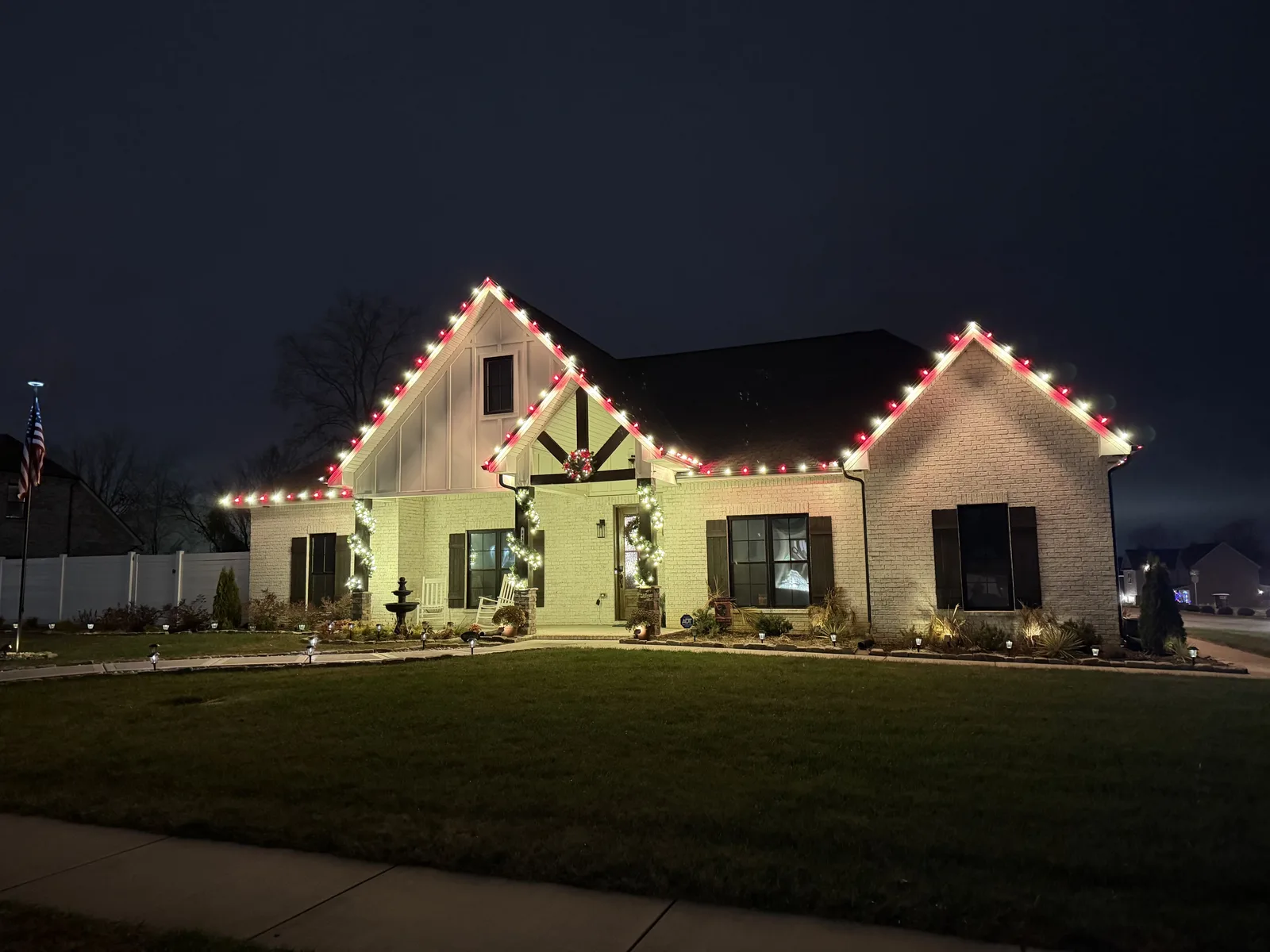 Red and green Christmas lights along a home’s roofline